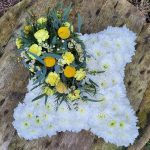 Funeral tribute cushion with yellow top spray